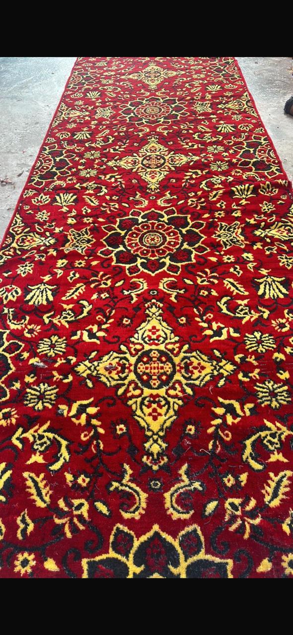Handcrafted red and gold floral medallion wool runner rug with traditional Persian design